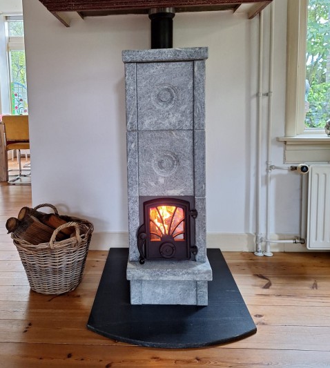 Foto : Hytta: traditionele speksteenkachel met krachtige warmte