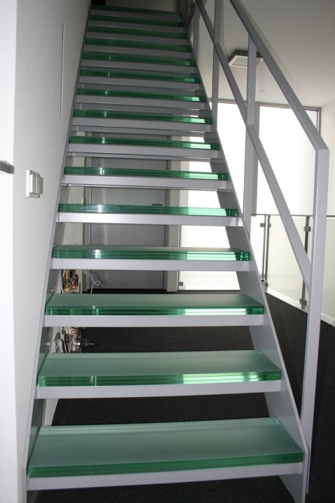Foto : Een adembenemende open stalen steektrap met glazen treden